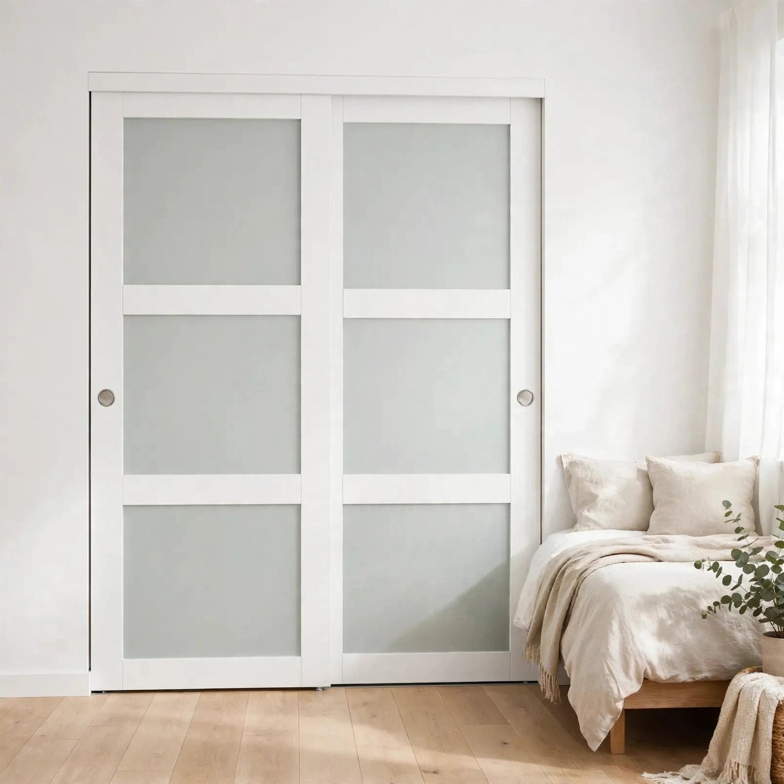 White framed frosted glass sliding closet doors in a Nordic bedroom